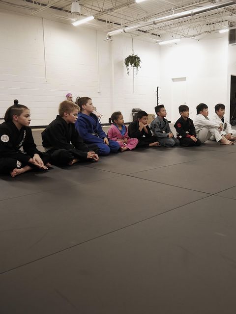 Kids training on the mat at Theory Jiu Jitsu