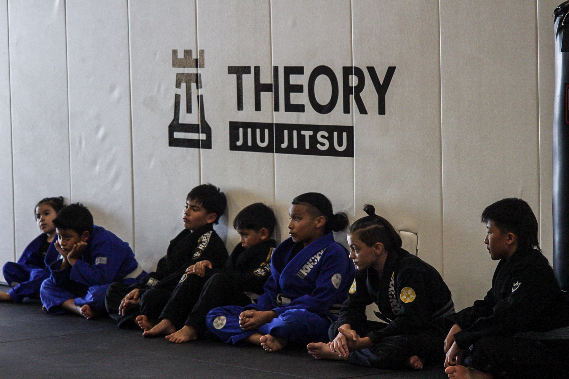 Kids training on the mat at Theory Jiu Jitsu